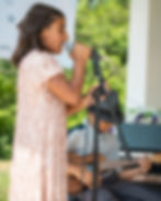 Girl singing into microphone at kids open mic event