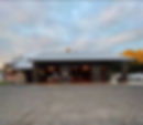 Porky's Belly BBQ Restaurant building, rustic brown barndominium structure.