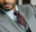 Man wearing a fashionable suit paired with a red tie