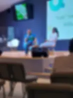 A picture of Kenneth and a colleague on stage during a professional mental health forum