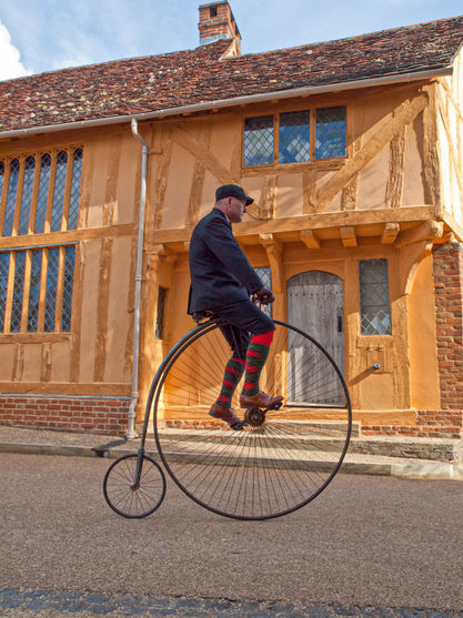 Man riding a Penny Farthing bicycle, England.jpg