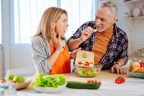middle aged couple eating together