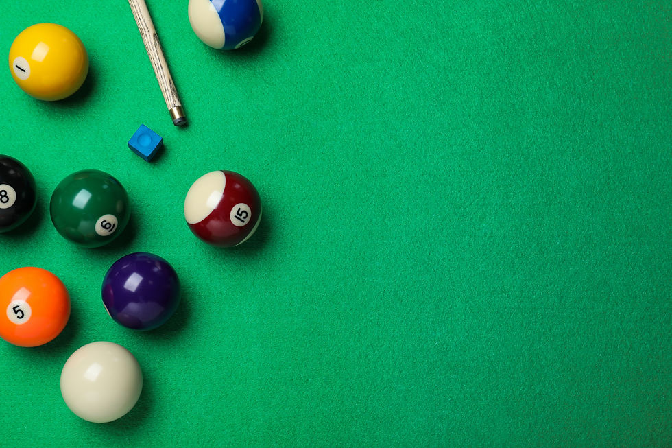 overhead view of billiards table with balls and pool cue