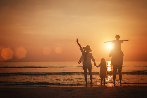 family at the beach at sunset