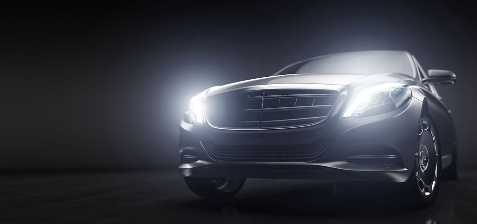 Luxurious cars, limousines in garage with lights turned on.