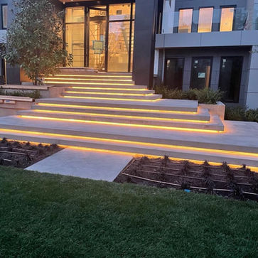 new luxury home with concrete front stairs