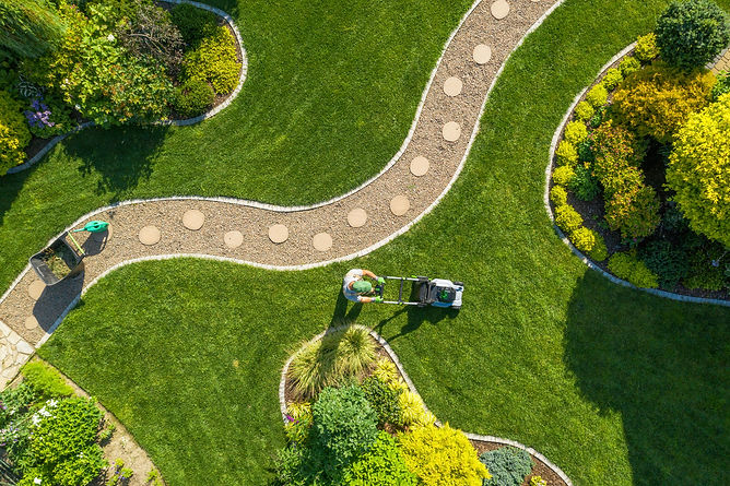 overhead view of landscaper contractor mowing the lawn