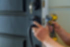 professional locksmith installing or repairing a new deadbolt lock, residential