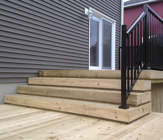 Wooden stairs and metal railing of deck