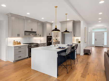 kitchen in new luxury home with waterfall island, quartz counter tops, farmhouse sink
