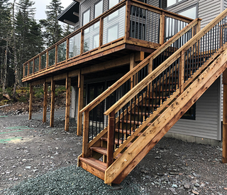 New wooden fence, stairs and deck of modern house