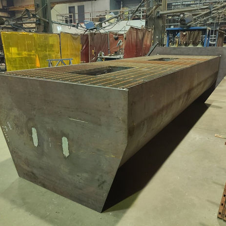 Large fabricated structural steel component in a workshop.