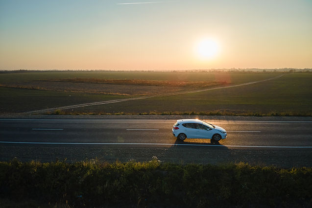 Aerial view of intercity road with blurred fast driving environment friendly electric car 