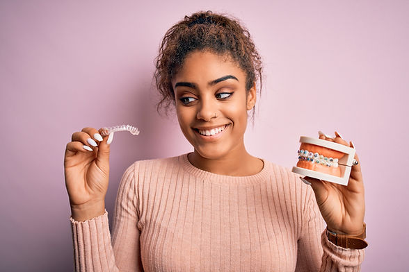 woman choosing between braces or clear aligners