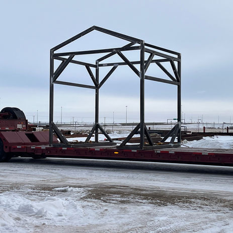 Structural steel building frame on a flatbed trailer