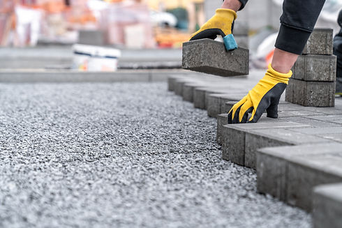 laying interlocking pavers during the construction of sidewalks and roads_