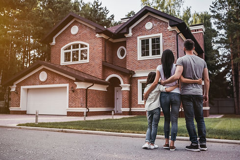 family in front of new home