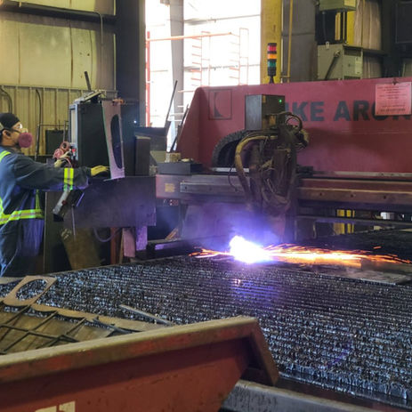 Worker operating structural steel plasma cutting machine