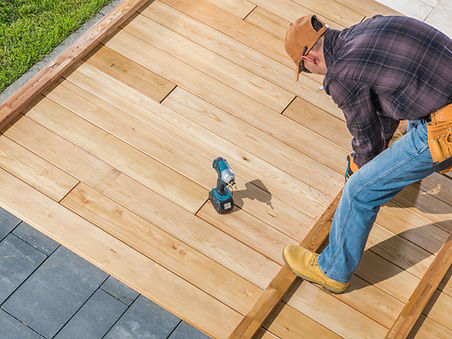 Contractor building deck with wood and stone