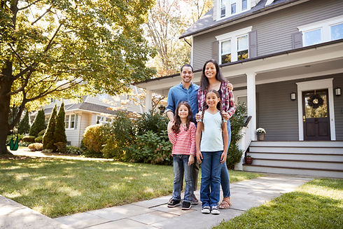 happy family in front of home