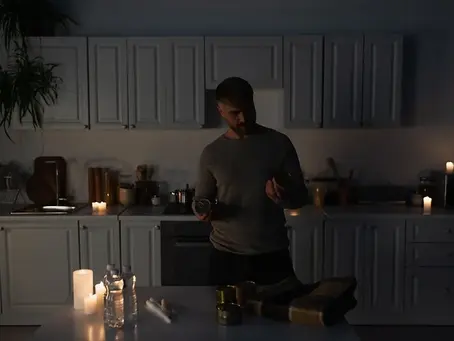 person lighting candles at home due to power outage