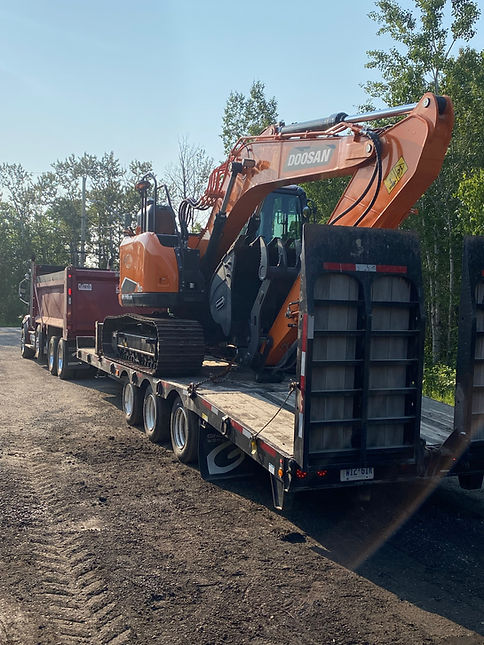excavator on a flatbed truck