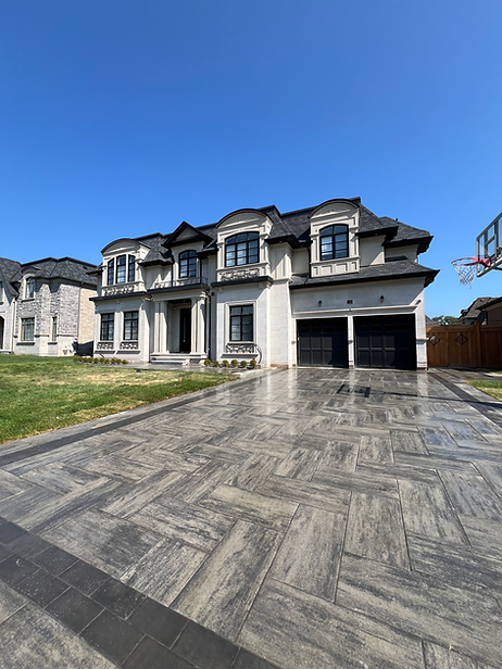 modern home with interlocking stone driveway