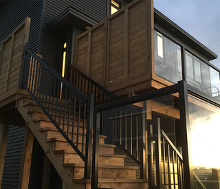 Modern deck and stairs from backyard to second storey