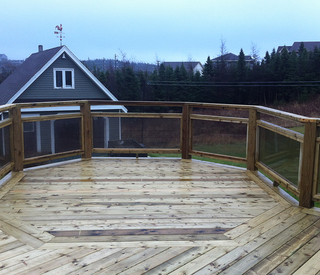 Large wooden deck and backyard