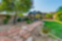 backyard with stone and gravel walkway to covered area