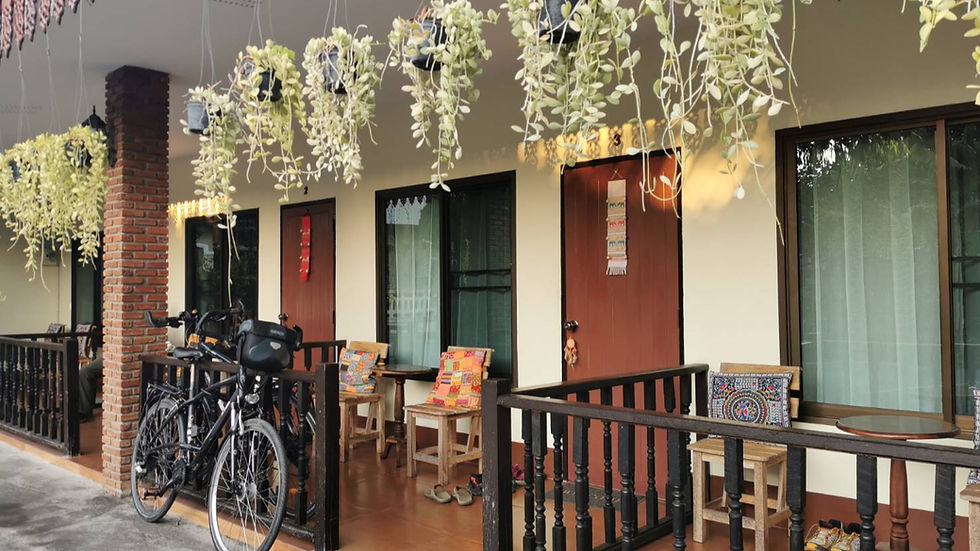 High angle view of a bicycle parked near a green garden path at Baan Gita Chiang Rai