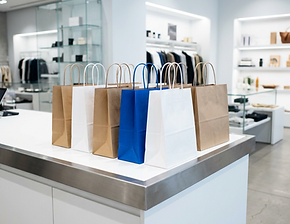 Modern-retail-counter-kraft-and-white-paper-shopping-bags-with-twisted-handles.jpg