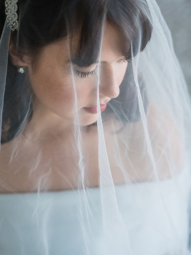 bride close up portrait. Head shot portrait through wedding veil