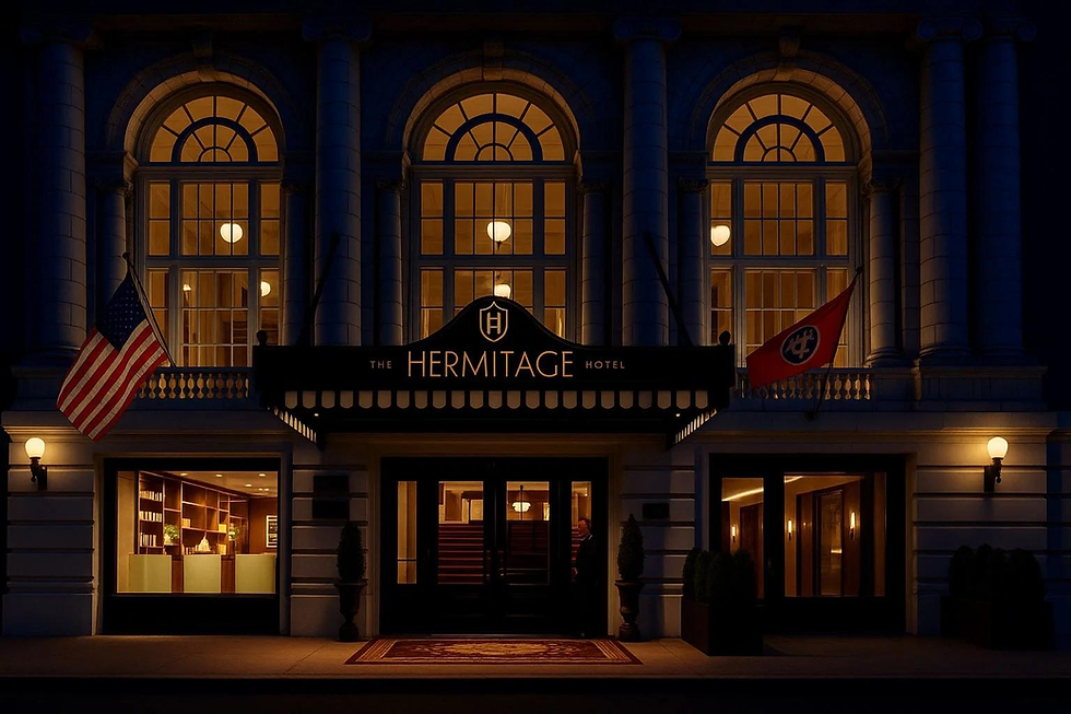 Illuminated Hermitage Hotel entrance at night with arched windows. U.S. and Tennessee flags visible. Warm, inviting ambiance.