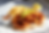 Fried chicken on white bread with pickle slices, crinkle fries, and baked beans on a bright takeout tray.