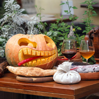 Wine and Halloween pumpkin on the table