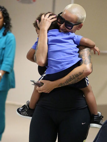 Amber Rose In A Playful Moment With Her Son As They Wait To Catch A Plane...