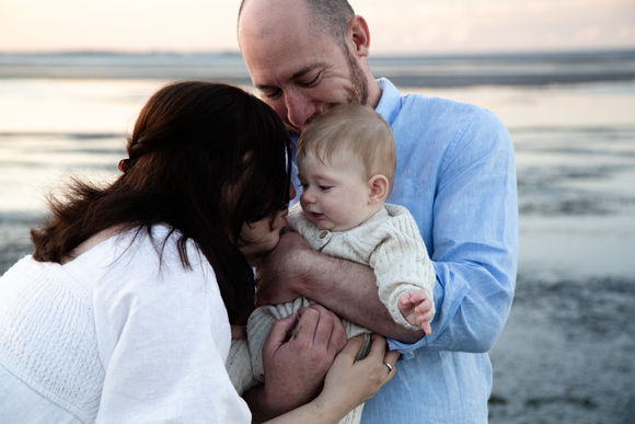 Family cuddles at the beach