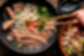 eating pho with brisket and sriracha sauce from overhead view_edited.jpg