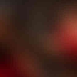 cool lens affect of woman looking in mirror with vintage hairstyle in red robe staring at her reflection