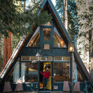 Staying at the Sugar Pine Speakeasy, a cozy A-frame cabin in Lake Tahoe with vaulted ceilings, large windows, rustic décor, plush bedrooms, a soaking tub, backyard deck with hot tub, and surrounding pine trees