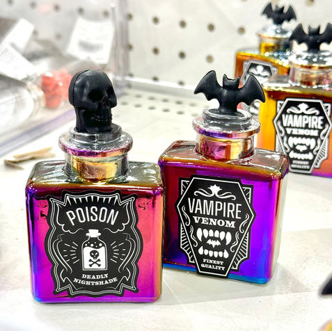 Iridescent potion bottles with black labels from the Target Bullseye's Playground sale bins. These bottles have black stoppers and include vintage labeled with poison names.