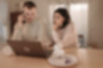 A couple searching the internet for home restoration services