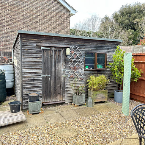 'Before' photo of a garden shed, showing how it looked pre restoration