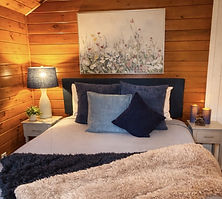 Queen bedroom inside Toasted Marshmallow cabin at Babbling Brook Cottages in Dingmans Ferry, Pennsylvania.