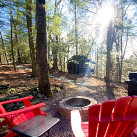 Sunset view over a 1942 log cabin at Babbling Brook Cottages Dingmans Ferry