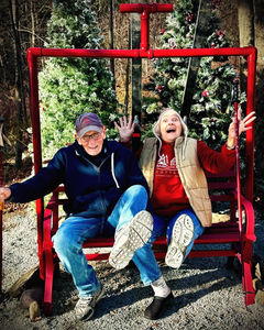 Guests enjoying the ski lift photo spot during Christmas Cabins season at Babbling Brook Cottages in Dingmans Ferry Pennsylvania.