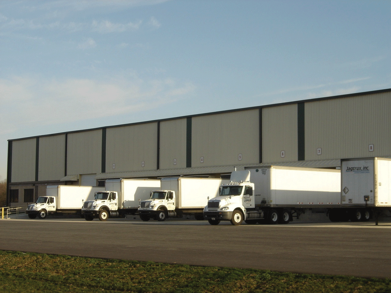 Cartage trucks loading at a warehouse