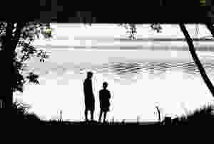 A dad and his child looking out at the lake.
