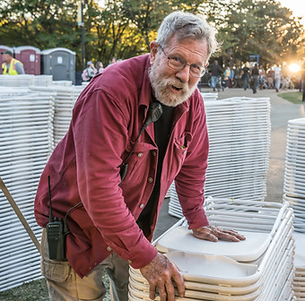Operations volunteer stacking chairs
